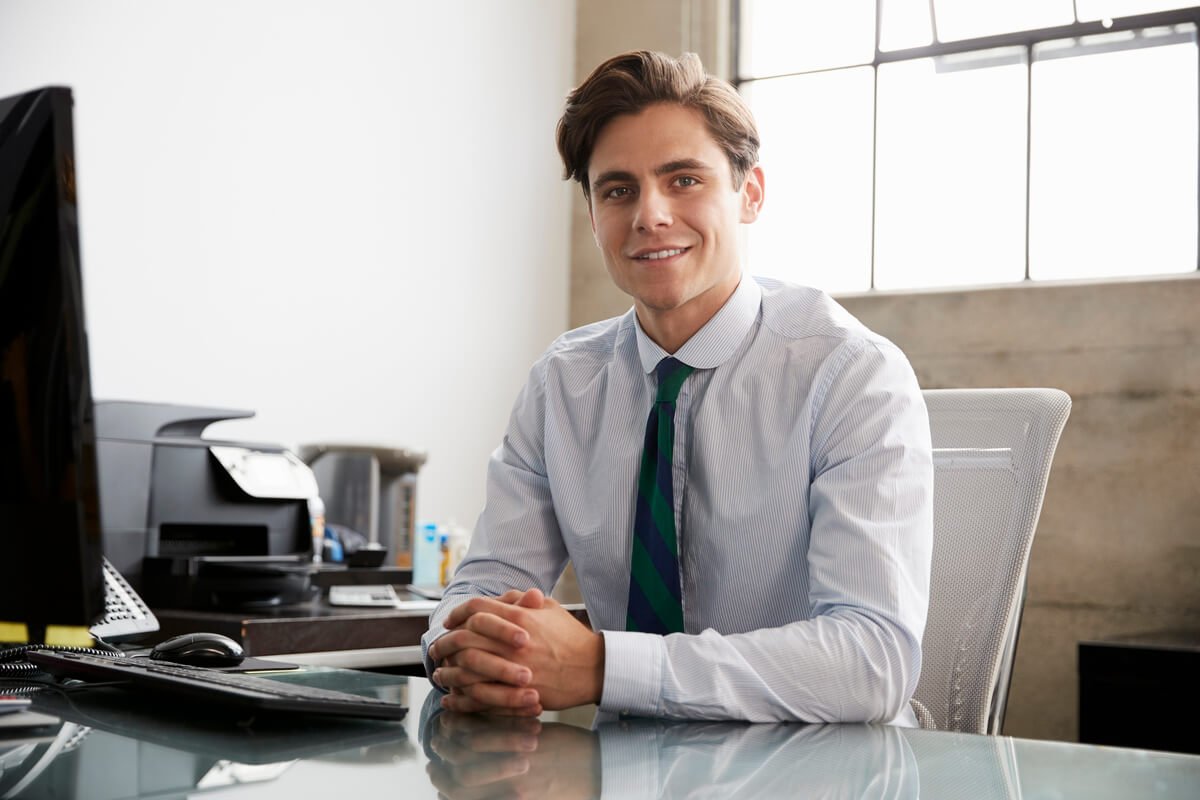 Young White Businessman At An Office Desk Smiling 2024 10 19 02 18 24 Utc